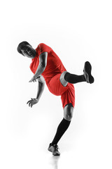 Professional football soccer player in motion isolated on white studio background