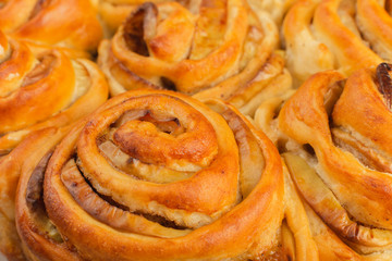 Pie with apples and cinnamon on a wooden background with ingredients.