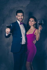 Portrait of trendy stylish couple having wineglasses with red wi