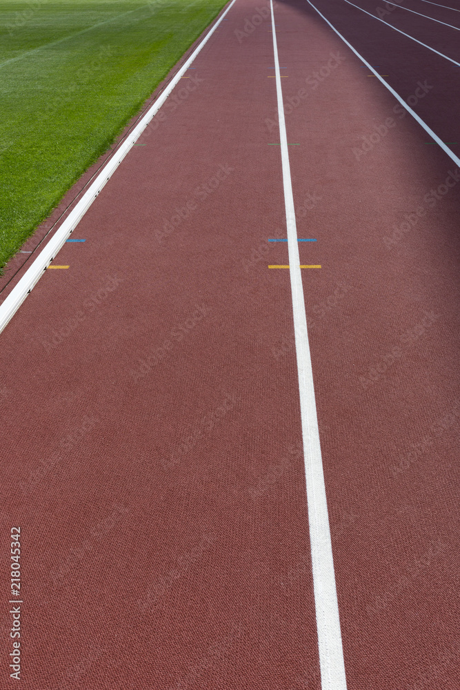 Sticker red sport track for running on stadium close-up shot. running healthy lifestyle concept. sports back