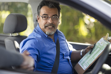 Driving instructor shaking hands with learner driver