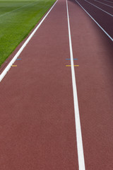 Red sport track for running on stadium close-up shot. Running healthy lifestyle concept. Sports...