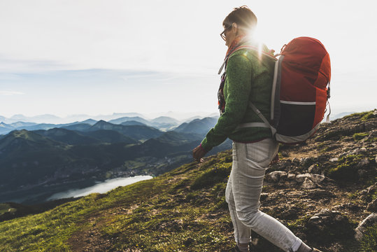 Austria, Salzkammergut, Hiker with backpack hiking in the Alps - Powered by Adobe