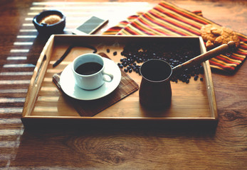 Light snack at the office with a cup of coffee costs on the spacing, the mobile phone is near
