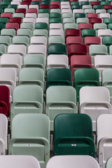 Empty tribunes of a modern stadium without spectators and colored chairs