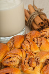 Pie with cinnamon and sugar on a wooden background.