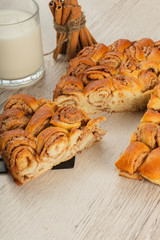 Pie with cinnamon and sugar on a wooden background.