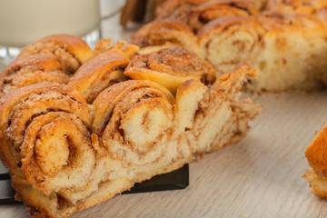 Pie with cinnamon and sugar on a wooden background.