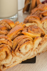 Pie with cinnamon and sugar on a wooden background.