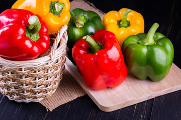 Three sweet peppers on a wooden background, Cooking vegetable salad