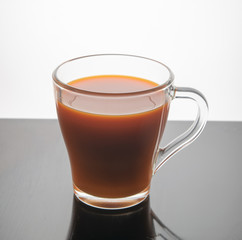 A glass of carrot juice on a white background