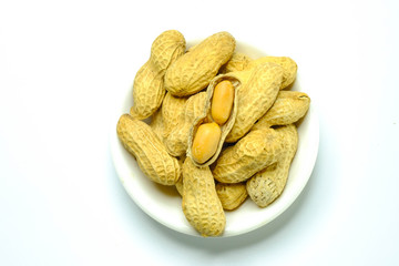 Peanuts isolated on the white background. Close up in blow