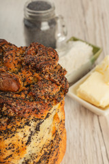 Cake with poppy seeds on a wooden background and ingredients.