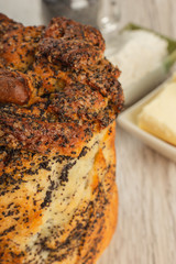 Cake with poppy seeds on a wooden background and ingredients.