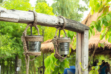 Stainless steel water tanks that hung on a log for a bath.