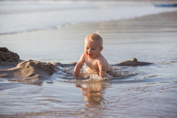 Little baby boy, playing on the beach