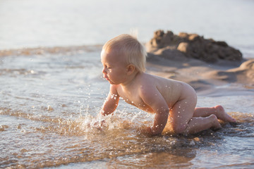 Little baby boy, playing on the beach