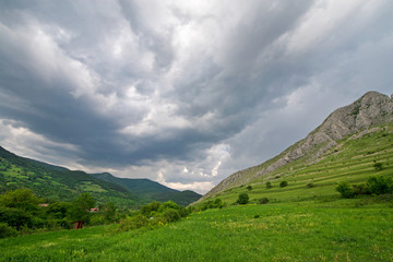 Early morning thunder storm clouds  over a mountain peak, where tourists climb to conquer fear, find courage and develop lateral thinking skills to overcome the difficulty of climbing a mountain.  
