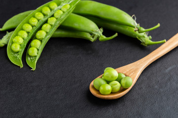 Sugar snap peas with mint on a rustic wood background