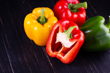 Three sweet peppers on a wooden background, Cooking vegetable salad