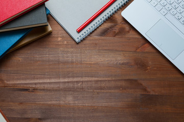 Office table with notebook, laptop, book. Copy space. Top view.