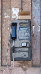 An old telephone on the street of Havana city, Cuba 