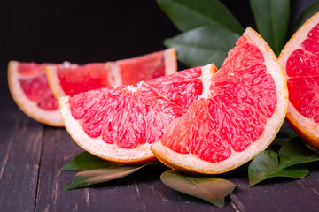 orange and grapefruit juice On a wooden black background