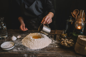 Steps of making cooking pie with ingridients. Mixing ingredients: flour, eggs, oil. See series. Step by step recipe. Cooking course or kitchen mess. Female hands make dough for biscuit or pie.