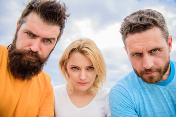 Obraz premium Suspicious look. Threesome suspiciously look down. Woman and men look confident sky background. Strength in unity. Stand up for their position. Group people suspect you. They know what you did