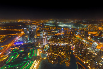 Dubai downtown night scene with city lights.
