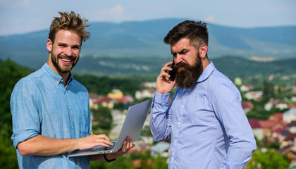 Colleagues with laptop work outdoor sunny day nature background. Mobile internet concept. Business partners in formal wear with laptop and phone taking advantages of mobile internet working outdoor