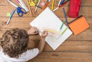 Child scribbling in a notebook.