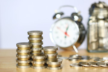 Stack of coins money and alarm clock on white background, Saving money for prepare in future and investment concept