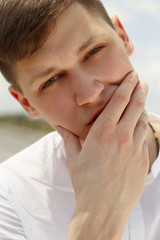 Fototapeta premium Portrait of handsome young man model posing at daylight