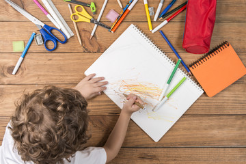 Child scribbling in a notebook.