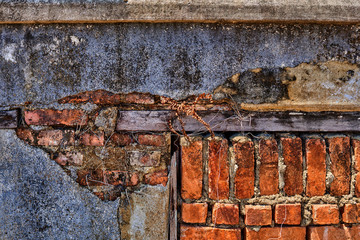Abstract old brick wall urban texture. Red brick wall with shabby damaged plaster. Cement and brick background of an  vintage dirty brick wall with exfoliating plaster.