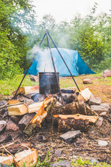 a camping, tent and fire in the forest