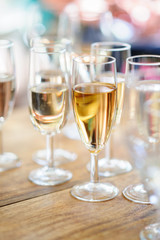 Champagne glasses on wooden table. Selective focus and shallow depth of field.