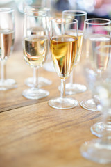 Champagne glasses on wooden table. Selective focus and shallow depth of field.