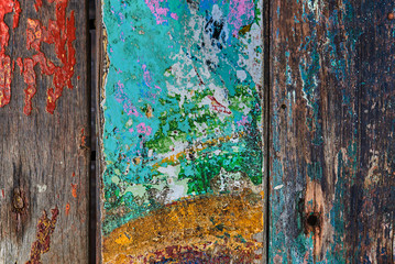 Creative wood background. Patterned and textures background of brightly colored planks. Room interior vintage with colorful wooden tiles. Art of colorful color on wooden wall. Weathered painted wood.
