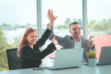 Business man and woman business hi five bump hand together for team work