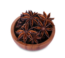 Chinese star anise seed in Chinese star anise seed in wooden bowl over the white background.