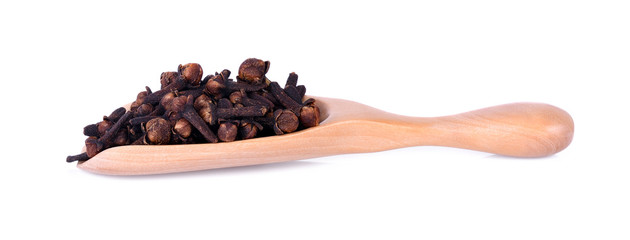 spicy dried clove, syzygium aromaticum flower buds in wooden spoon.