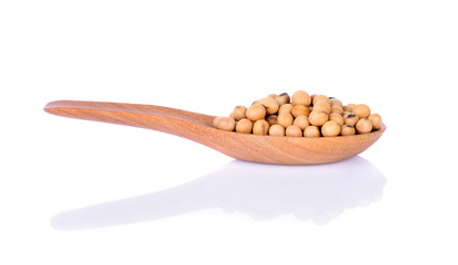 Soy beans in wooden spoon on white background.
