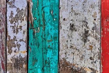 Creative wood background. Patterned and textures background of brightly colored planks. Room interior vintage with colorful wooden boards. Art of colorful color on wooden wall. Weathered painted wood.