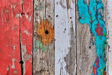 Grunge wood texture background. Colorful art wooden planks. Vertical stripes. Colored peeling  paint wooden texture. Bright colorful vintage wooden wall. Weathered painted wooden boards.
