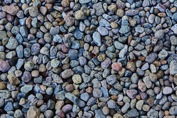 Dark texture pebble closeup. Pebbles on the shore. Natural  pebbles background.