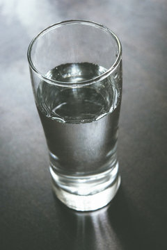 Water glass on wooden table
