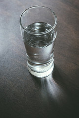 Water glass on wooden table