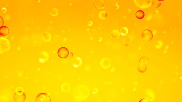 Golden orange bubbles rise upwards. Golden background with bubbles inside gold liquid for the project, oil, honey, beer, juice or other variants.